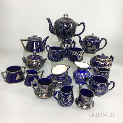 Twenty Pieces of Mostly Lenox Silver Overlay Cobalt Ceramic Teaware. Estimate $200-400
