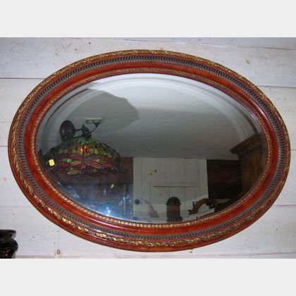 Two Parcel-gilt Framed Oval Mirrors