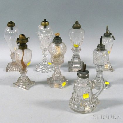 Eight Colorless Pressed Glass Fluid Lamps