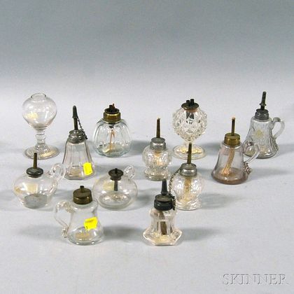 Twelve Colorless Blown and Pressed Glass Sparking and Hand Lamps