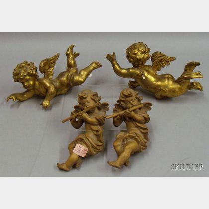 Four Carved Putti Figures
