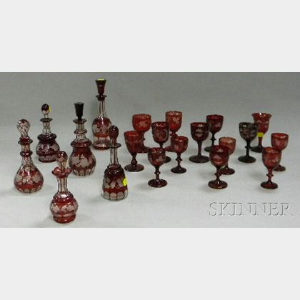 Five Bohemian Etched Ruby Flash Art Glass Decanters, Scent Bottles, and Fourteen Wine and Cordial Stems