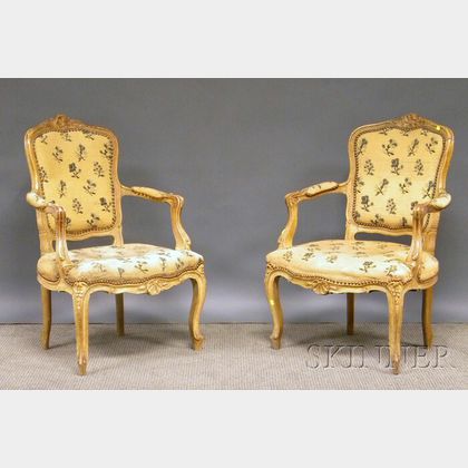 Pair of Louis XV-style Creme-painted Carved Beechwood and Needlepoint Upholstered Fauteuil. 