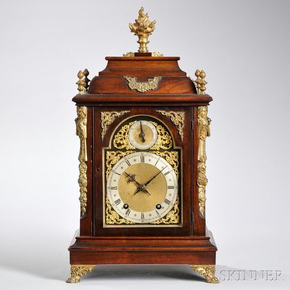 Mahogany Quarter-chiming Bracket Clock, A. Stowell & Co., Boston, c. 1900, step-molded dome-top case with central flame finial, above t