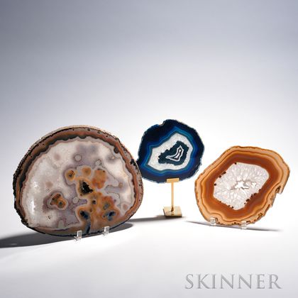 Three Geode Cross-section Discs, each with hues of brown, purple, and blue, sold with one stand, ht. to 12 1/4, wd. to 15 1/4 in. 
